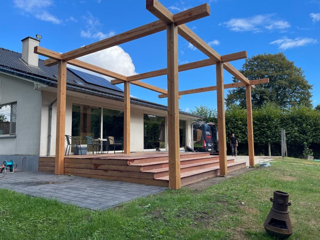 Zijaanzicht van de douglas-pergola en Cumaru terras met trap naar de klinkers